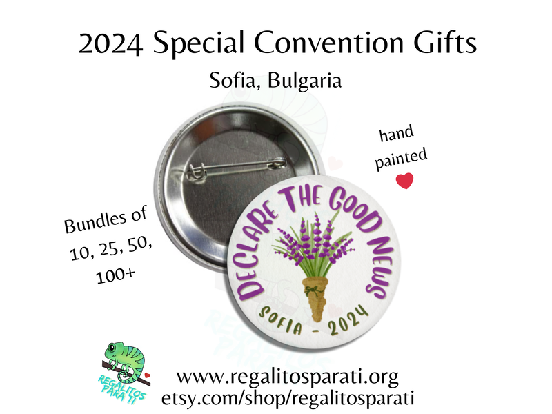 Pin back button with a hand painted lavender floral design and the text "Declare the Good News Sofia 2024"
